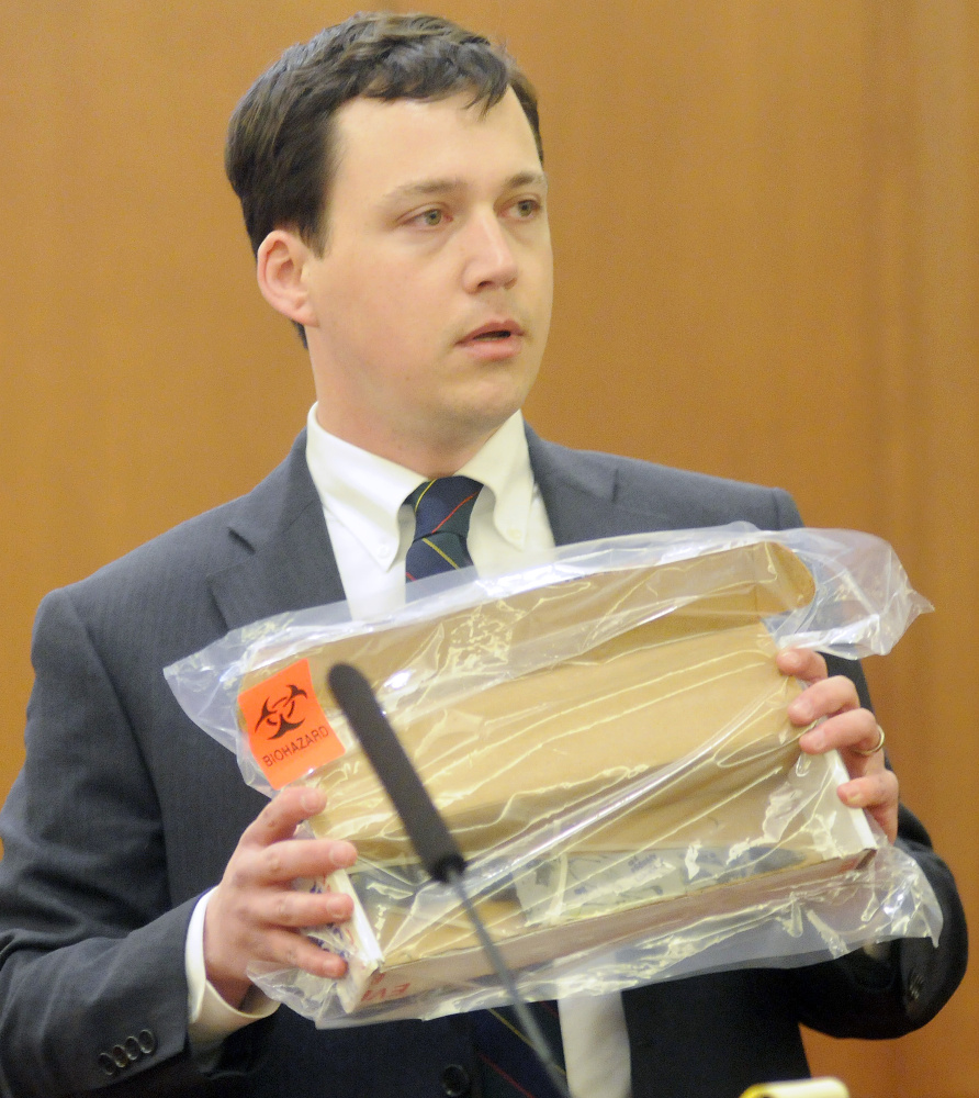 Defense attorney Caleb Gannon holds a knife that he says Jillian Jones used to assault Justin Pillsbury at their Augusta apartment in Nov. 2013. Pillsbury is standing trial for the stabbing death of Jones.