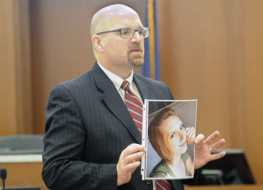 Assistant Attorney General Donald Macomber holds a photo of Jillian Jones Monday during opening arguments of the murder trial of Justin Pillsbury. Pillsbury, 41, claims he was defending himself from Jillian Jones, 24, who died of several stab wounds at their Augusta apartment in Nov. 2013.