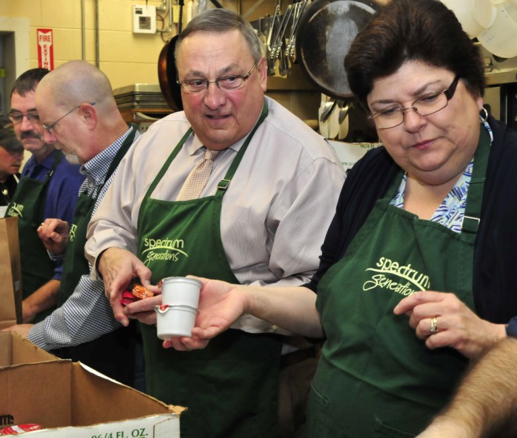 Gov. Paul LePage, right, got in line and helped prepare meals for the Meals on Wheels program during the March for Meals celebration at the Muskie Center in Waterville on Thursday. Also helping, at left, are Waterville Councilors Sidney Mayhew and Steve Soule, and Linda Fossa, Waterville director of Health and Welfare.