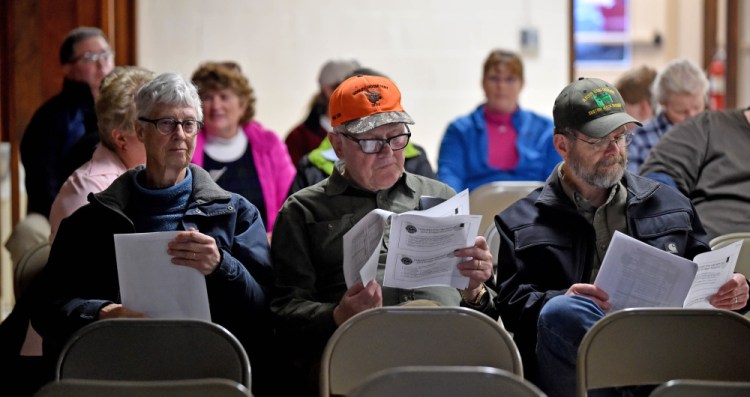 Joanne Gooley, left,  Walter Gooley, center, and Michael Chase, right, read through the budget proposal for the Farmington Fire Department during a meeting at the Community Center in Farmington on Wednesday.