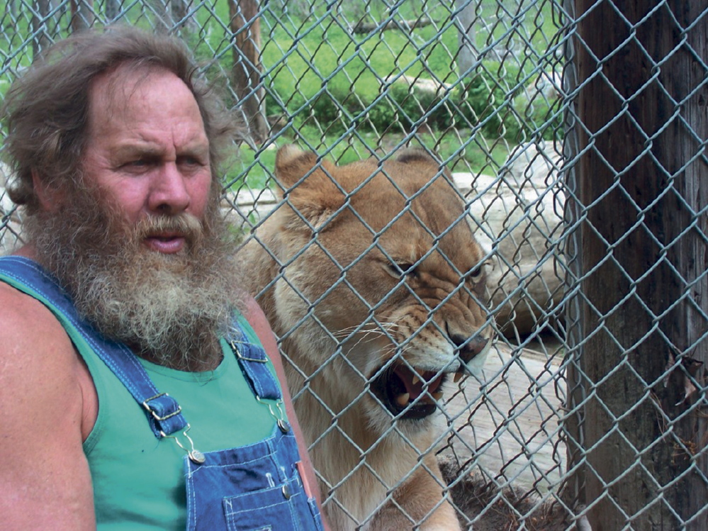 Bob Miner, owner of DEW Haven in Mount Vernon, is seen in this 2011 photo with an African lion at the animal sanctuary. An article published by Mother Jones magazine says an Animal Planet TV show documenting DEW Haven was canceled after the magazine reportedly uncovered evidence of animal welfare violations going back decades.