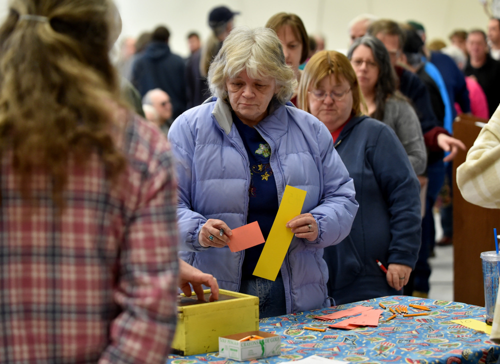 Canaan residents cast their secret ballots Saturday in a vote on Article 5 at Town Meeting at Canaan Elementary School in Canaan.