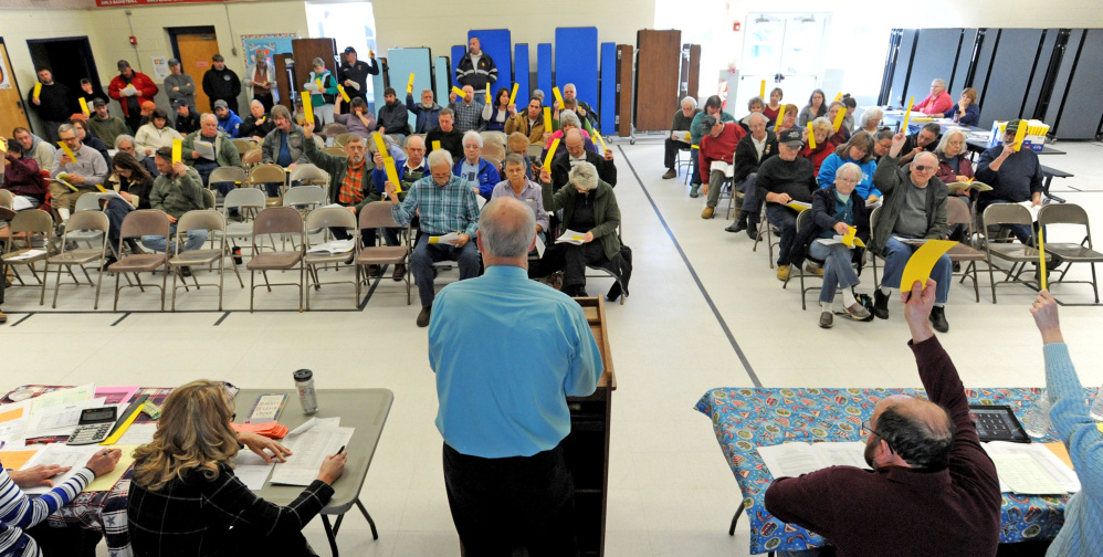 Canaan residents show their votes Saturday during the Town Meeting at Canaan Elementary School in Canaan.