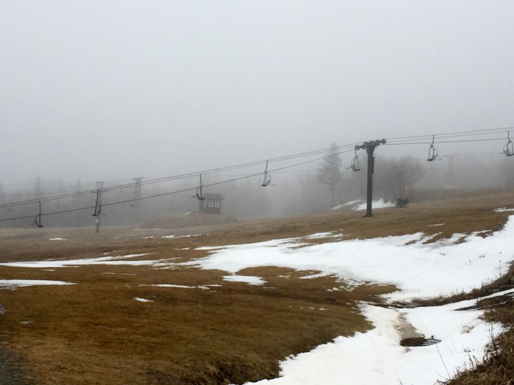 After a winter without use, a chairlift hangs in place over a thawing Saddleback mountain on Wednesday.