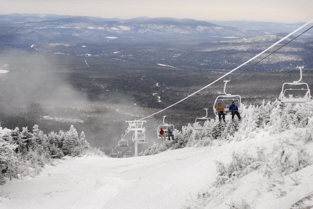 Skiers ride the Kennebago Quad chairlift at Saddleback Mountain in 2008. 