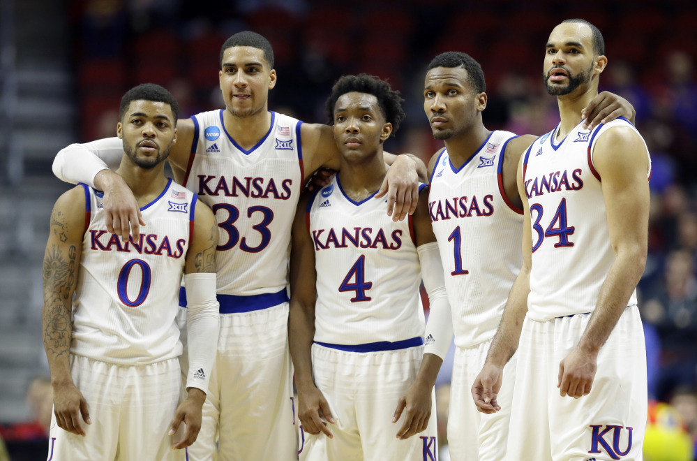 Kansas players, from left, Frank Mason III, Landen Lucas, Devonte’ Graham, Wayne Selden Jr. and Perry Ellis gather during the second half of a second-round NCAA tournament game against Connecticut on Saturday in Des Moines, Iowa.