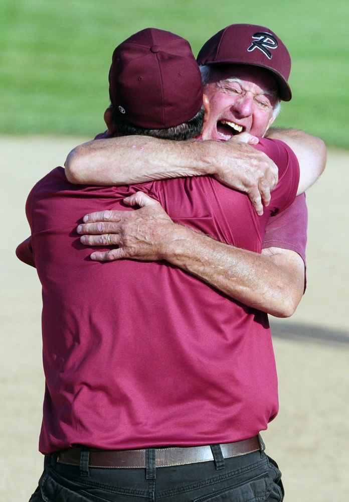 Richmond softball coach Rick Coughlin embraces Tony Martin after the Bobcats won the Class D state title last season. Coughlin recently resigned, citing health concerns.