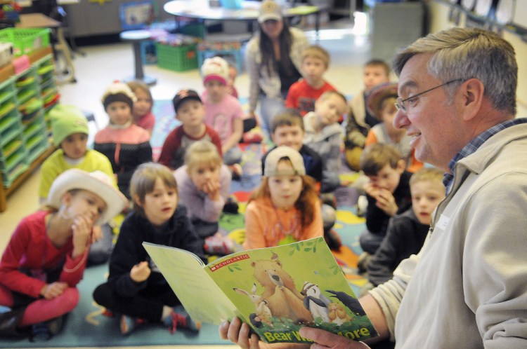 Augusta businessman John Lajoie reads Tuesday to Hussey Elementary School first graders in Arielle Roy’s classroom during the school’s first read-a-thon. Several local prominent people read to kids as part of initiative to engage them in reading.
