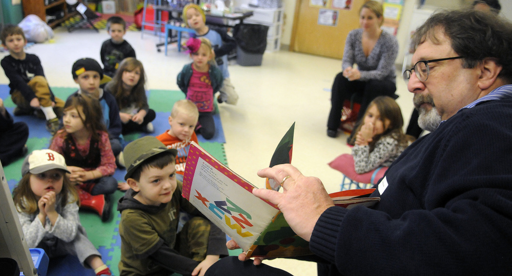 Mark O’Brien turns pages while reading to kindergarten students in the Hussey Elementary School kindergarten classroom of his daughter, Brittany, during the school’s first read-a-thon on Tuesday. Several local prominent people read to kids as part of initiative to engage them in reading.