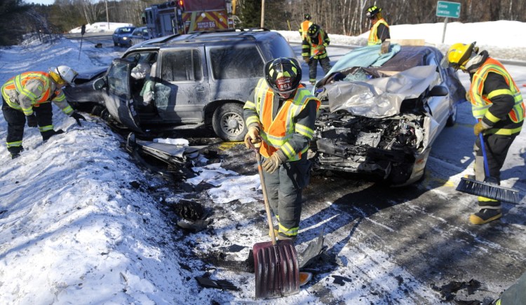 Monmouth firefighters collect debris from a two-car collision that killed Joan Fortier on March 6, 2014, on Route 202 in Monmouth. Her husband, John Fortier of Mount Vernon, has filed a lawsuit seeking damages against the drivers involved.