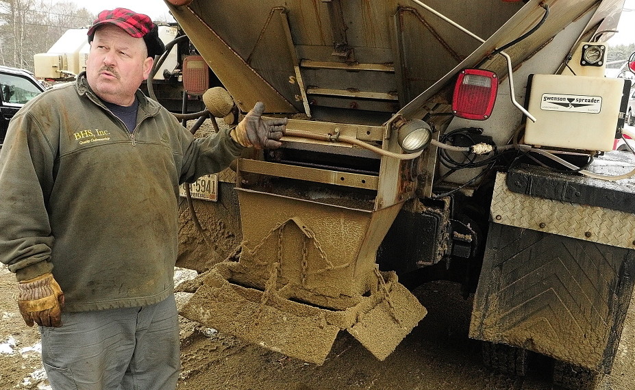 Chris Ellis, an owner of Ellis Construction, talks about the calcium chloride dispensers on his plow trucks on Dec. 10, 2013, at Ellis Construction in Farmingdale.