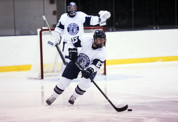 In this Nov.  8, 2014, Geneseo’s Matthew Hutchinson skates with the puck during a game against SUNY Plattsburgh in Geneseo, N.Y. When the Knights arrive in Lake Placid to prepare for their second Division III Frozen Four in three years, they’ll keep an empty stall in the locker room at Herb Brooks Arena in memory of the guy they call “Hutch.” Hutchinson, a former defenseman, was found dead inside a Geneseo home in January, a victim in a violent attack that also took the life of senior Kelsey Annese, a guard on the Geneseo women’s basketball team.