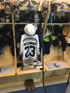 The SUNY Geneseo hockey team has kept the locker of slain teammate Matthew Hutchinson intact, and added the team’s hard hat and SUNYAC championship trophy as well.