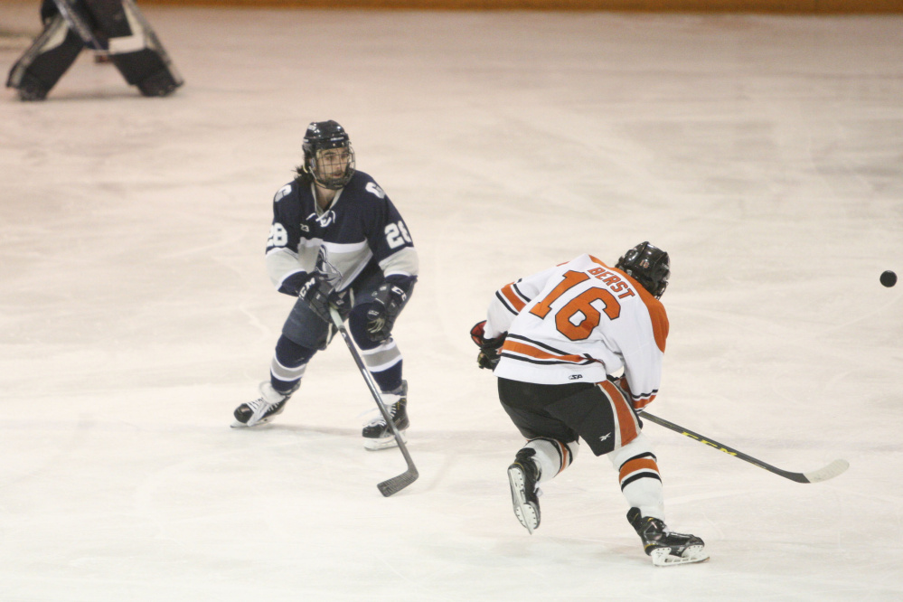 Waterville Senior High graduate Matty Lee, left, a junior on the SUNY Geneseo men’s hockey team, breaks up a play in a game earlier this season.
