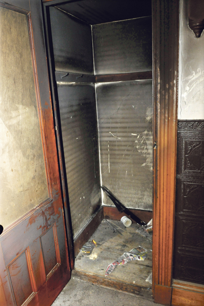 The charred interior of a closet in the lobby of an apartment building that was damaged in a suspicious fire at 58 Silver St. in Waterville late Sunday.