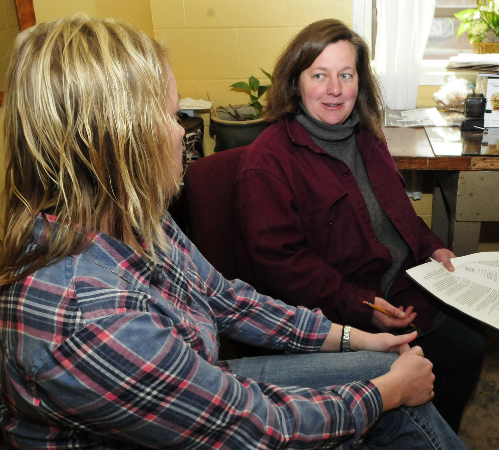 Kristina Cannon, left, director of Skowhegan Main Street, and Amber Lambke, chairwoman of the TIF Oversight Committee, consult in an office at the Maine Grains in Skowhegan on Tuesday.