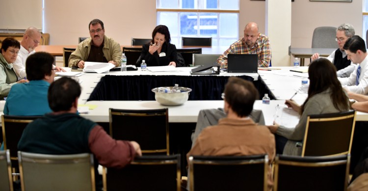 Waterville City Council members review budgets on Tuesday for information technology, health and welfare, planning, code enforcement, economic development and the Fire Department in the Council Chambers at City Hall in Waterville.