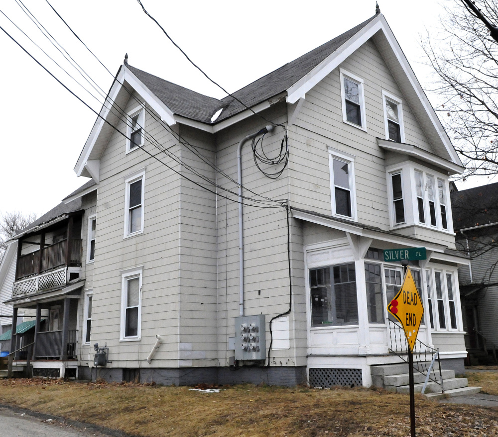 A fire that caused damage late Sunday to this apartment building at 58 Silver St. in Waterville was intentionally set, a state fire official said Monday.