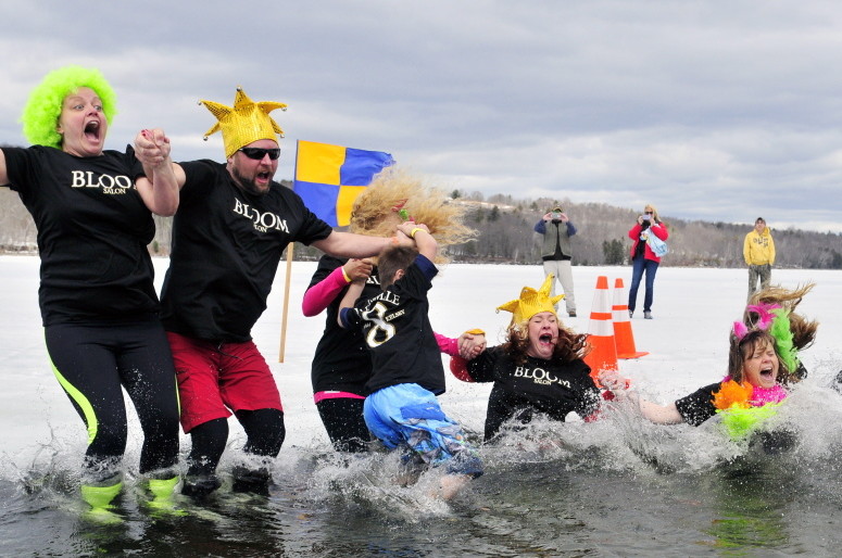 The Bloom/Kelsey team takes their plunge into Maranacook Lake during the Ice Out Plunge Special Olympics fundraiser in this April 11, 2015, file photo.