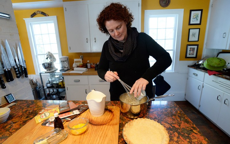 Christine Burns Rudalevige mixes ingredients for her pie in her Cape Elizabeth kitchen.