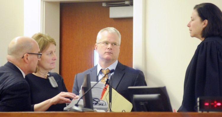 Superior Court Justice Michaela Murphy, right, holds a sidebar conference with prosecution and defense attorneys Monday during the opening arguments of the murder trial of Justin Pillsbury. Pillsbury, 41, claims he was defending himself from Jillian Jones, 24, who died of several stab wounds at their Augusta apartment in Nov. 2013.