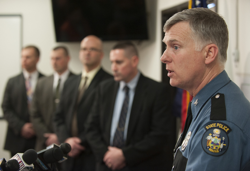 Flanked by detectives, Maine State Police Col. Robert Williams briefs the media on the arrest of Philip Scott Fournier in connection with the 1980 death of high school student Joyce McLain.