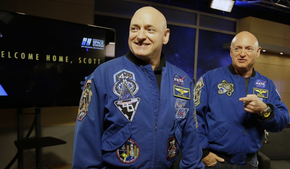 NASA astronaut Scott Kelly, left, and his twin, Mark, meet before a press conference Friday in Houston. They both took part in medical studies during Scott Kelly’s flight.