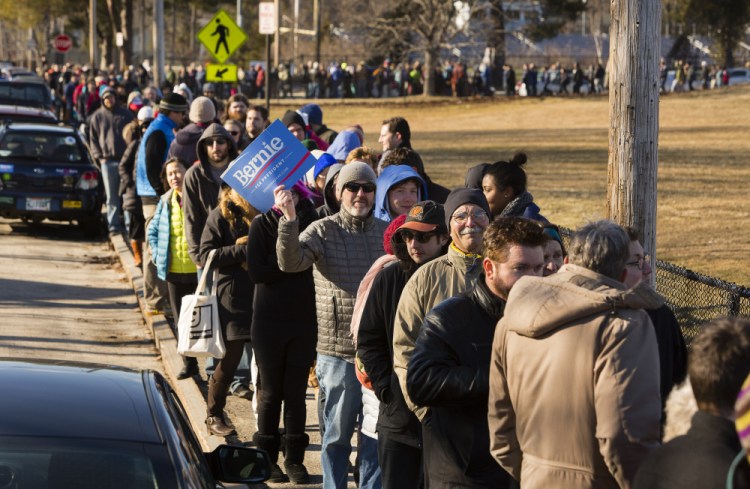 Voters wait in line to take part in the Democratic caucus at Deering High School in Portland on Sunday.  
Carl D. Walsh/Staff Photographer
