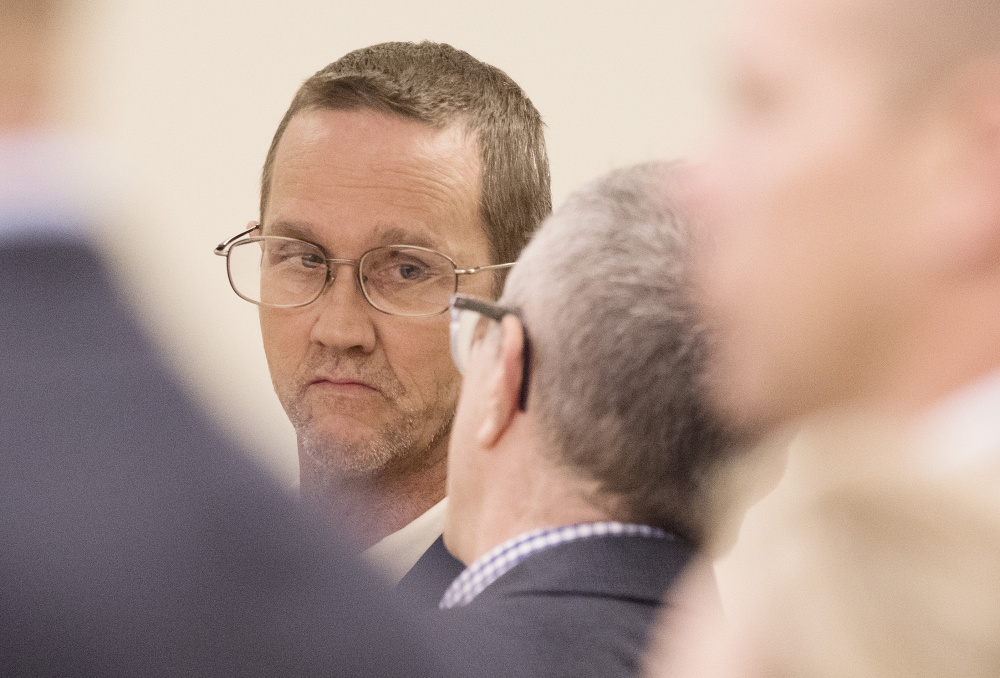 Philip Scott Fournier listens to attorney Jeffrey Silverstein, at the Penobscot Judicial Center in Bangor on Monday, during his initial appearance on a homicide charge in connection with the 1980 death of high school student Joyce McClain.