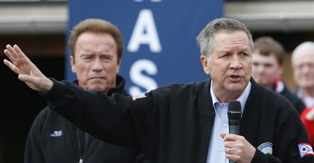 Ohio Gov. John Kasich addresses a rally on Sunday in Columbus, Ohio, where former California Gov. Arnold Schwarzenegger, left, endorsed him.