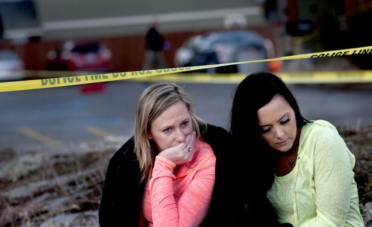 Amanda Padula, left, and Deborah Young on Sunday sit outside Altar Church in Coeur d’Alene, Idaho, where pastor Tim Remington was shot multiple times as he was leaving services earlier in the day. The two women said they benefited from Remington’s Good Samaritan Rehabilitation program.