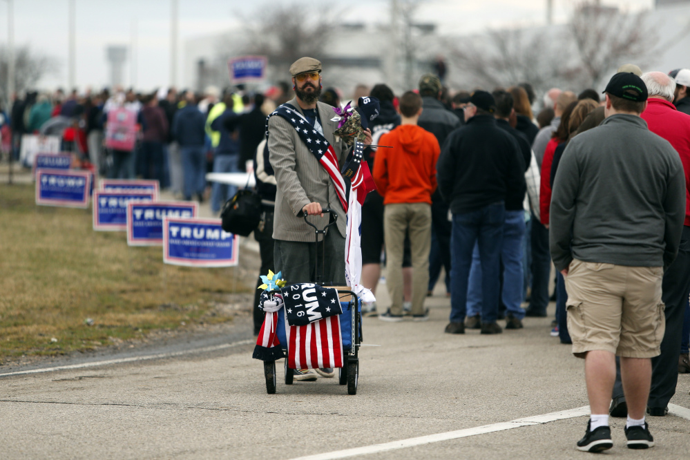 A vender sells Trump products as supporters line up outside of the Wright Brothers Aero Hangar for a rally by Republican presidential candidate Donald Trump Saturday in Vandalia, Ohio.