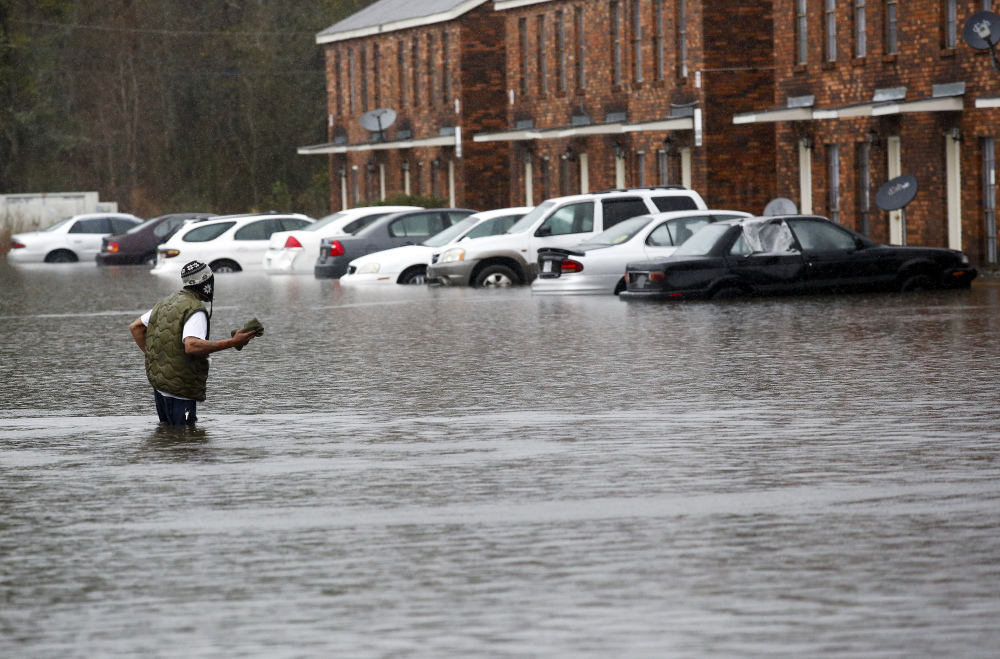 A man wades through floodwaters in Hammond, La., Friday. 