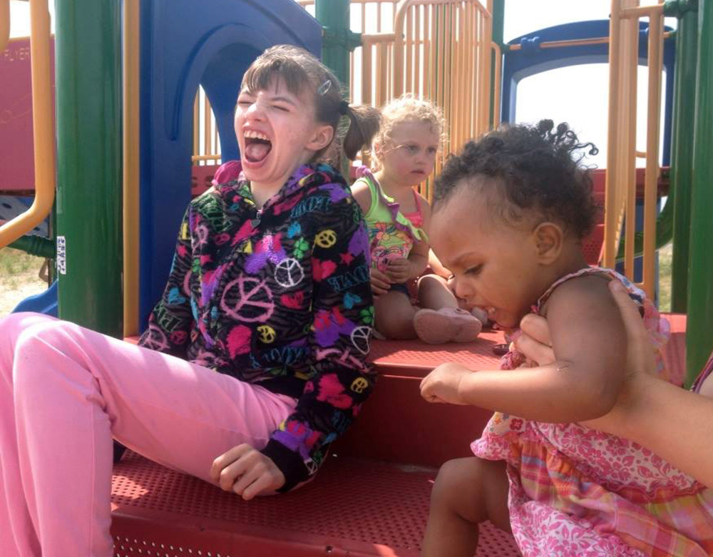 Cyndimae Meehan plays on a playground at Wells Beach with Kaylee Brown, center, and Daliyah Shaur, both of whom, like Cyndimae, have Dravet syndrome. Cyndimae died Sunday.