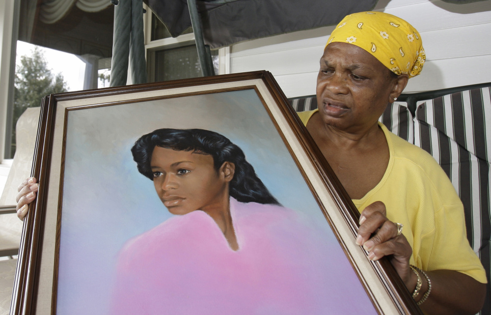 Bessye Middleton holds a painting of her daughter, Tryna, in Cleveland Heights, Ohio. Romell Broom faces execution for abducting, raping and killing the teen in 1984.