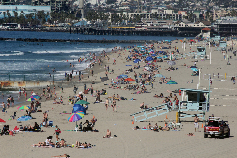 Swimmers and sunbathers gather at Redondo Beach, Calif., on Feb. 15 as Southern California baked in summerlike heat.