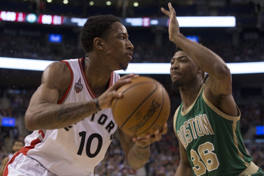 The Raptors’ DeMar DeRozan drives against Boston’s Marcus Smart in the second half of Friday night’s game in Toronto.