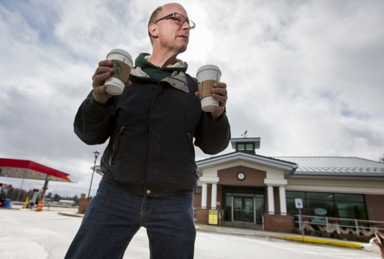 Mike Tehan of Winthrop holds two cups of coffee after leaving Starbucks at the Cumberland service plaza on the Maine Turnpike on Thursday. The rest stops at Mile 58 southbound in Cumberland and Mile 59 northbound in Gray will close Monday for nine weeks so the two Starbucks can be turned back into Burger Kings.
Ben McCanna/Staff Photographer