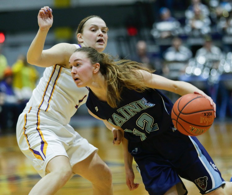 Maine guard Sigi Koizar of Austria drives in front of Albany guard Erin Coughlin during the first half an NCAA women's college basketball game in the America East Conference tournament championship on Friday in Albany, N.Y. 