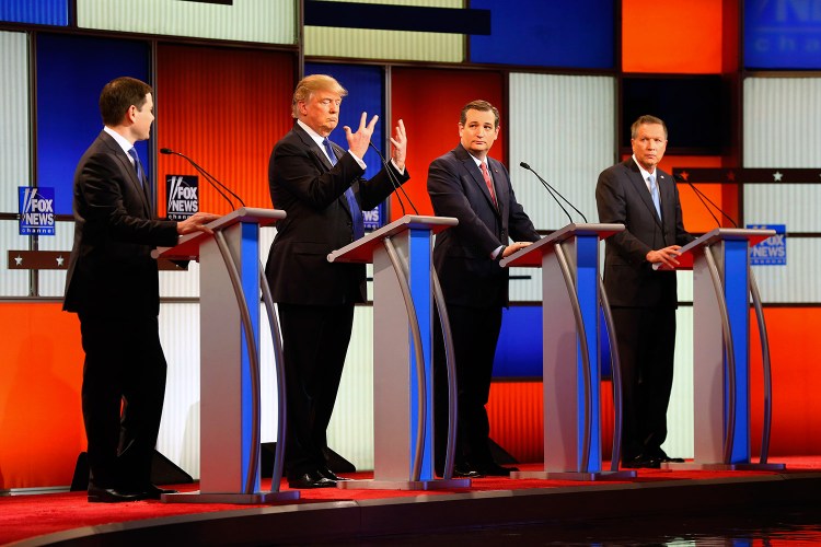 Donald Trump shows his hands as Marco Rubio, Ted Cruz and John Kasich watch. Trump noted that Rubio had mocked his hands as small – widely viewed as an insult about Trump's sexual prowess – and said, "I guarantee you, there's no problem" in that area.
The Associated Press