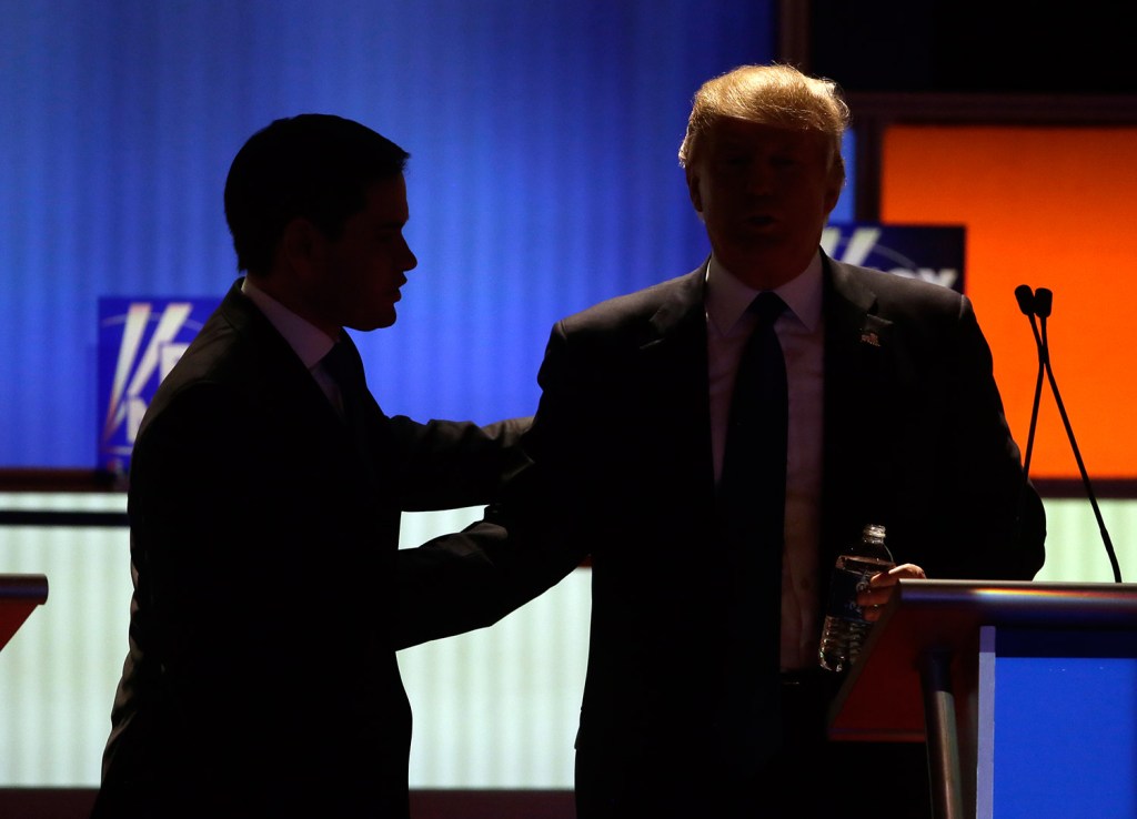 Rubio talks to Trump during a commercial break in Thursday night's debate.