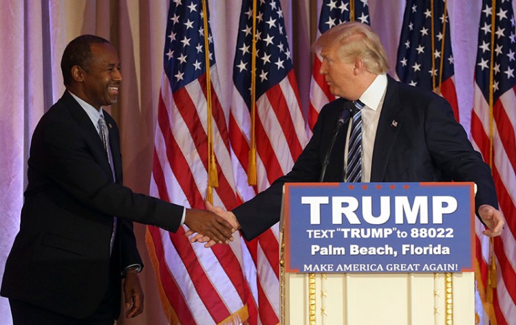 Former Republican presidential candidate Ben Carson shakes hands with Republican presidential candidate Donald Trump, after announcing he will endorse Trump.