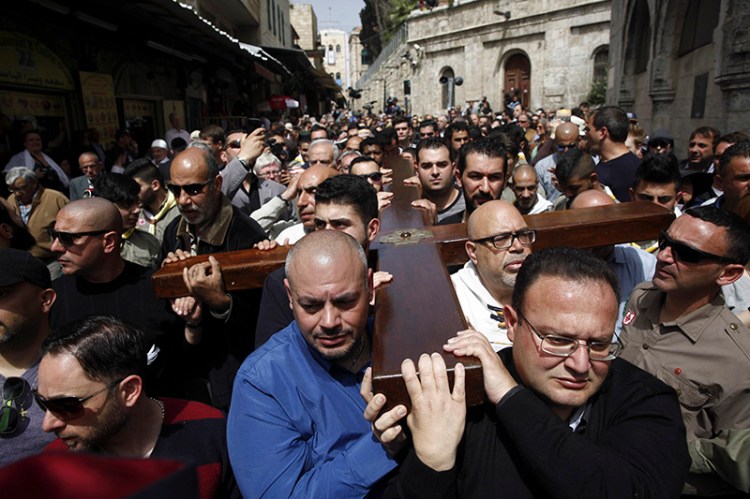 Catholics and Protestants commemorated the crucifixion of Jesus Christ by following the path in Jerusalem's Old City where, according to tradition, he walked on the way to the cross. 
