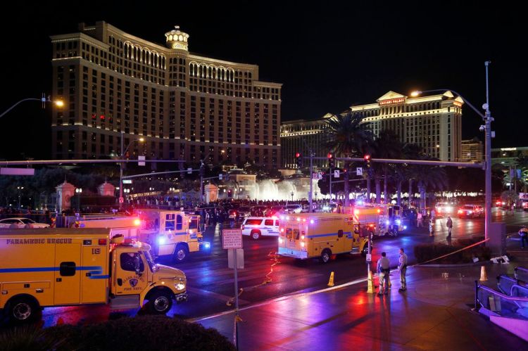 In this Dec. 20, 2015, photo, emergency crews respond to the scene of a car accident along Las Vegas Boulevard in Las Vegas, after a woman drove her car into a crowd of tourists outside the Planet Hollywood and Paris casino-hotels.  The Associated Press
