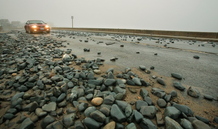 Rocks and seaweed cover Beach Avenue in Kennebunk. Splash over during the high tide overnight created minor flooding issues along parts of the coast. 