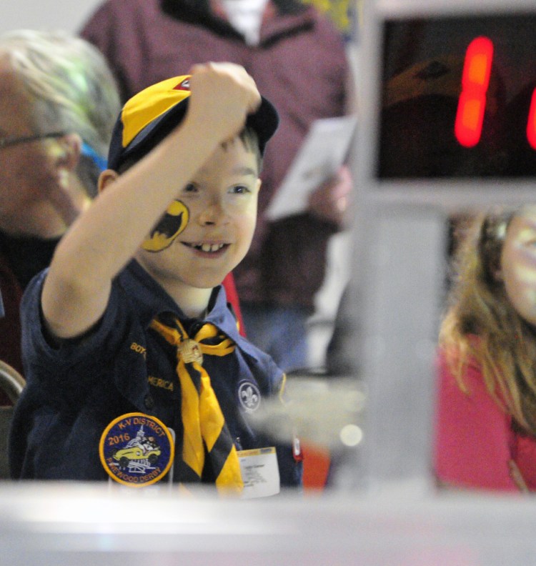 Landyn Grenier, 8 of Augusta, cheers as his car finishes Saturday during the Kennebec Valley District Pinewood Derby in Augusta.