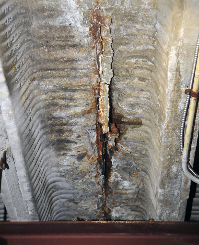 A rusted electrical conduit cracks through the cement ceiling in the basement of Hartford fire station on Friday in Augusta.
