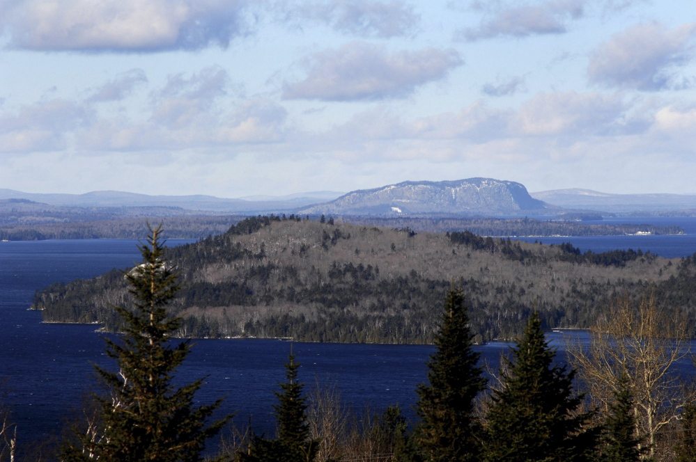 Moosehead Lake's iconic Mount Kineo rises over the lake. The Moosehead Region Futures Committee is expressing concern that energy company SunEdison might file for bankruptcy and says it is committed to defeating plans the company has to build a 26-turbine wind farm in Misery Ridge.