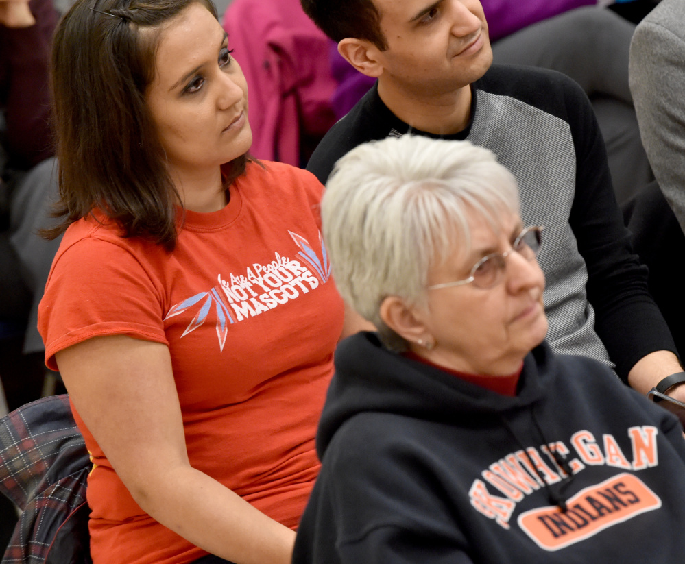 Maulian Smith of "Not Your Mascot Maine" sits with a shirt that reads "We Are A People Not Your Mascots" during a school board meeting at Skowhegan Middle School on Thursday.