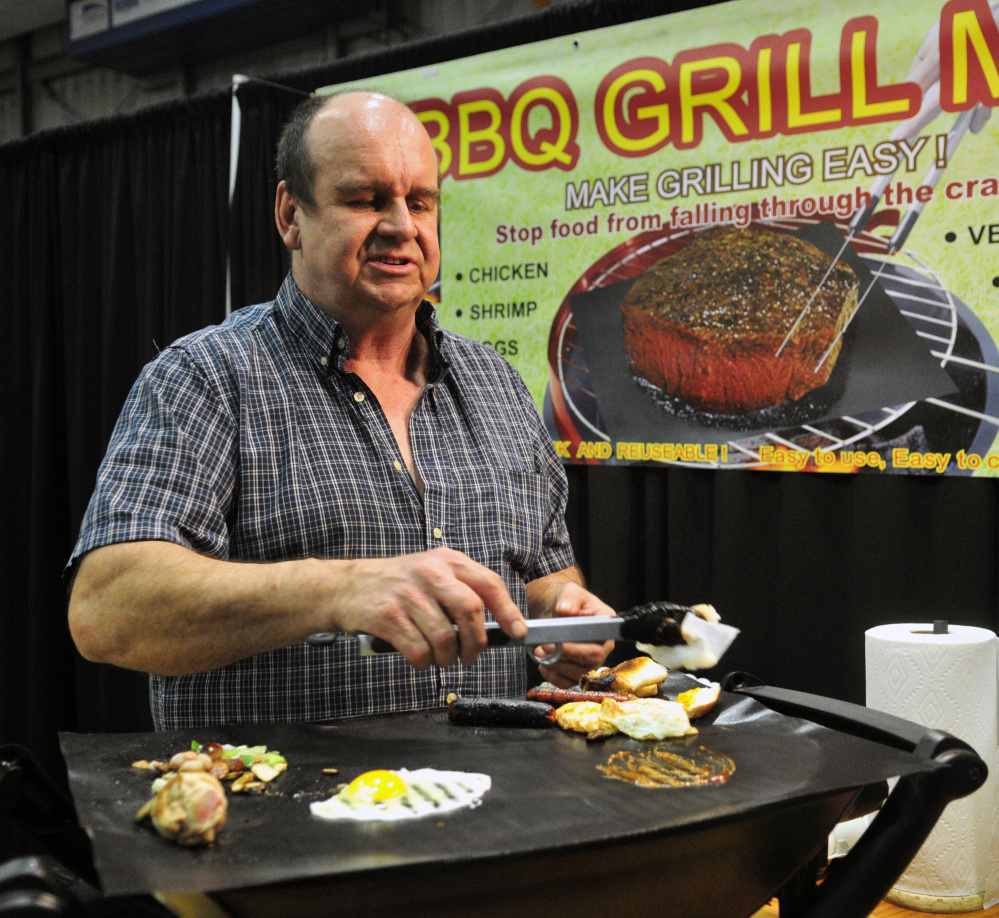 Duane Blous, of Another Look, demonstrates grill mats Friday during the 43rd annual Manchester Lions Club Home and Garden Show at the Augusta Civic Center.